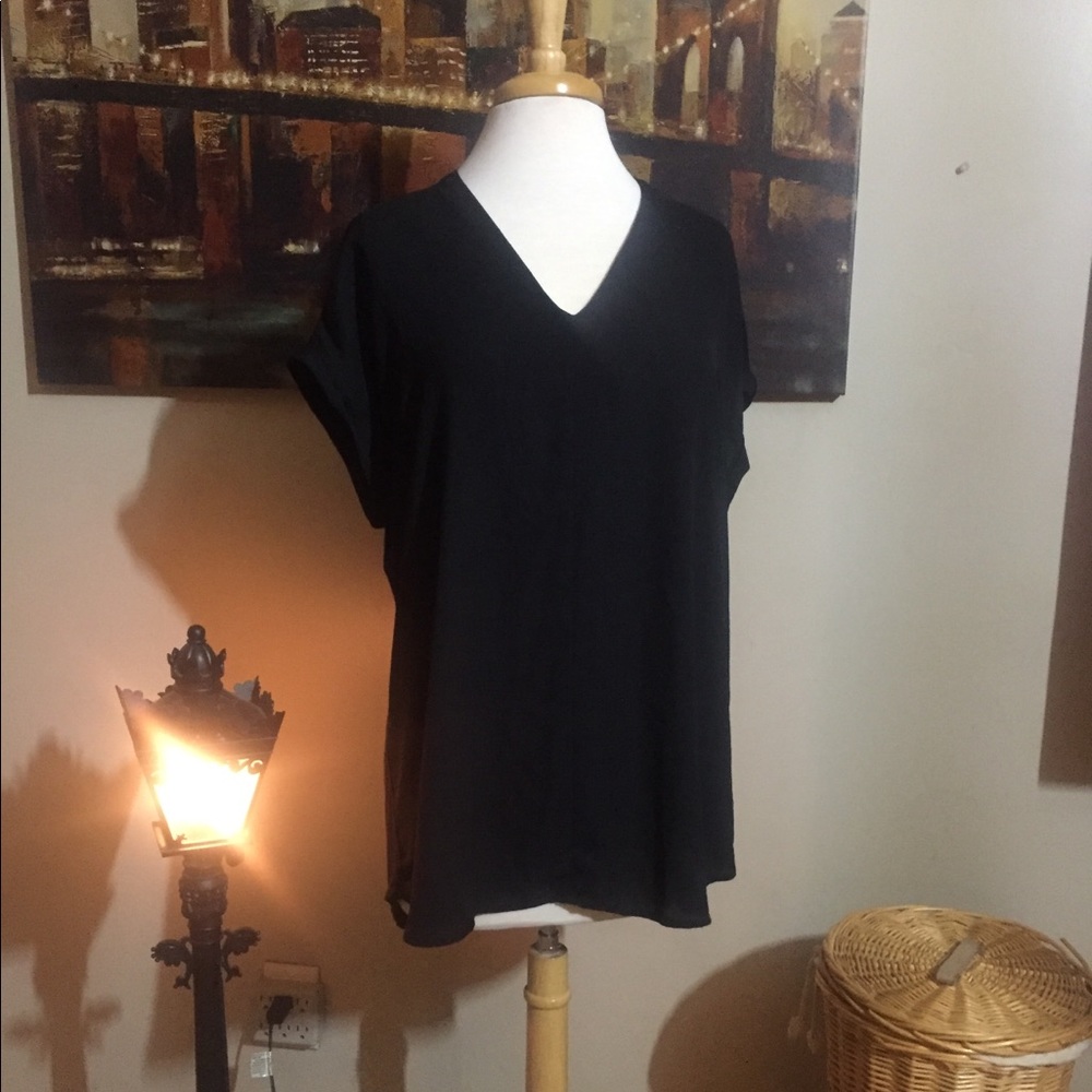 Solid black mixed material top. Cuffed sleeves
